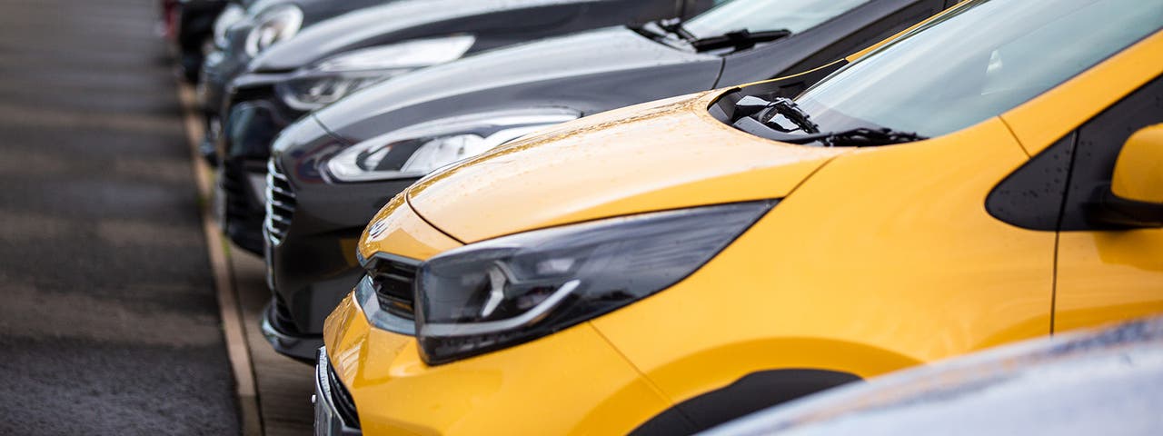 Close up of a row of cars at Motorpoint – a yellow Kia Picanto is in the foreground