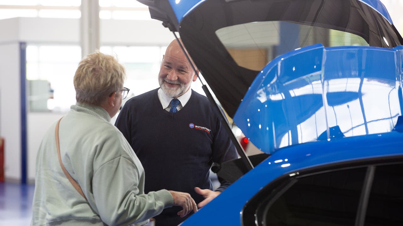 Customer with Motorpoint salesperson by a car's boot