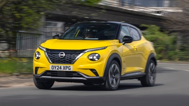 Yellow Nissan Juke Hybrid driving around a corner