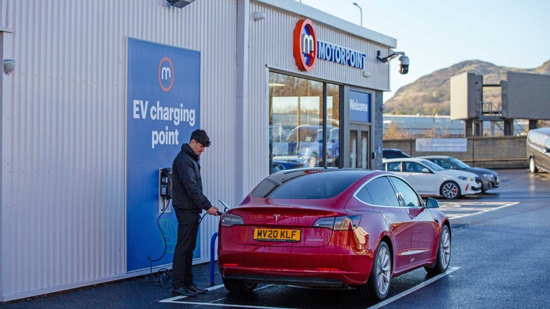 Tesla Model 3 being plugged in to charge at Motorpoint Edinburgh
