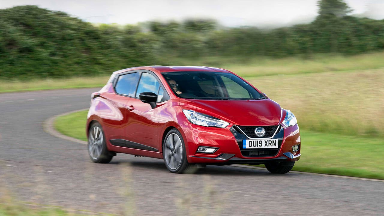 Nissan Micra in red, driving shot