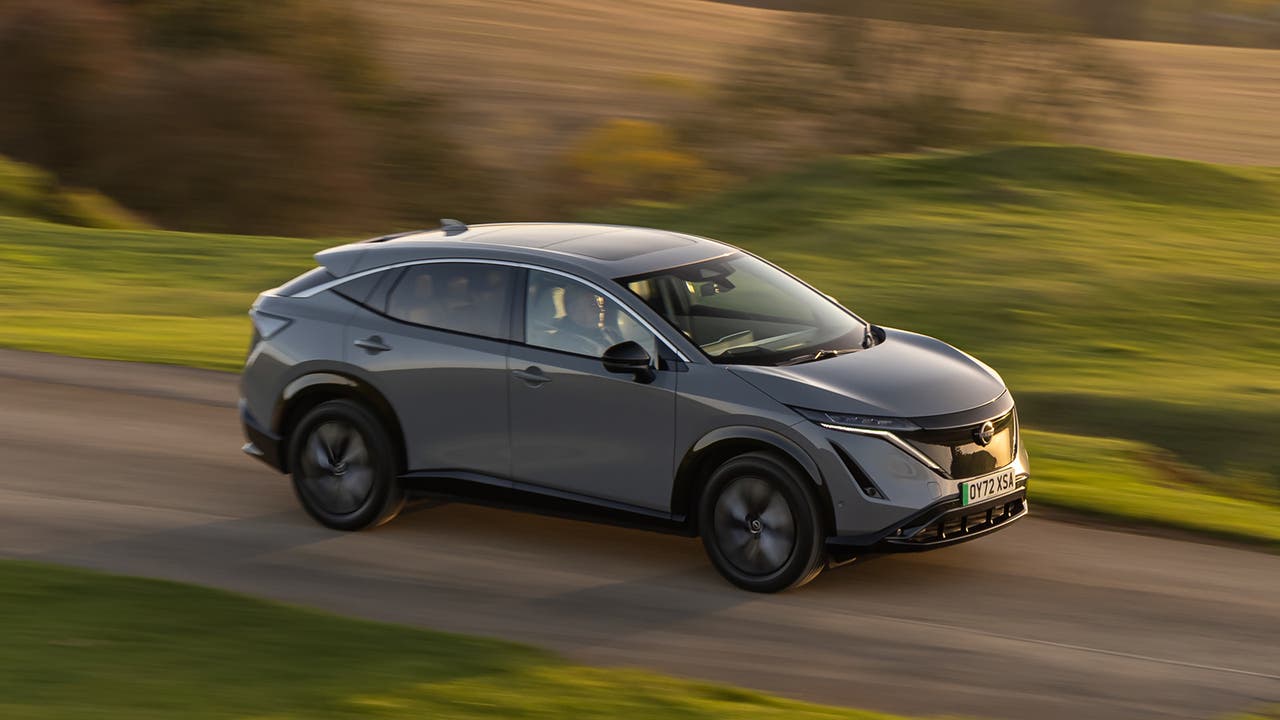 Nissan Ariya in grey, driving shot