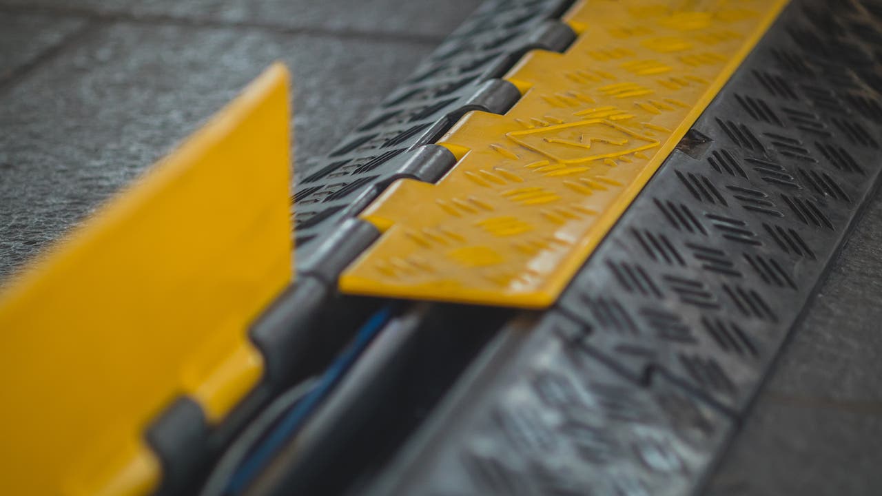 Charging cable protector on the pavement