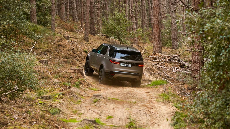 Land Rover Discovery in bronze, off road shot rear three quarter