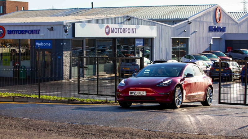 Tesla driving out of Motorpoint Edinburgh