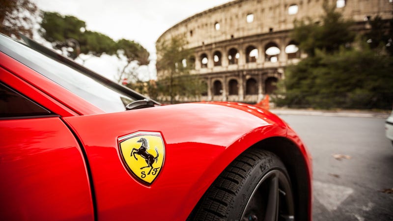Close up of Ferrari in front of Coliseum