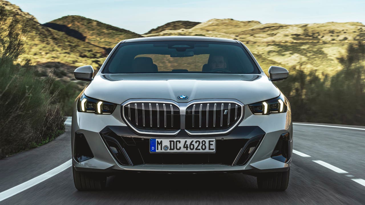 BMW i5 in grey. Front driving shot