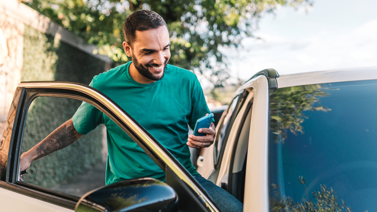 Happy man getting into car