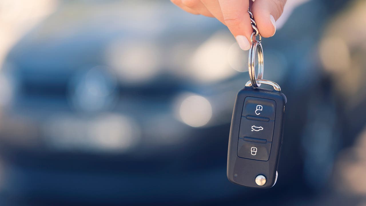 Car key closeup with blurry car in background