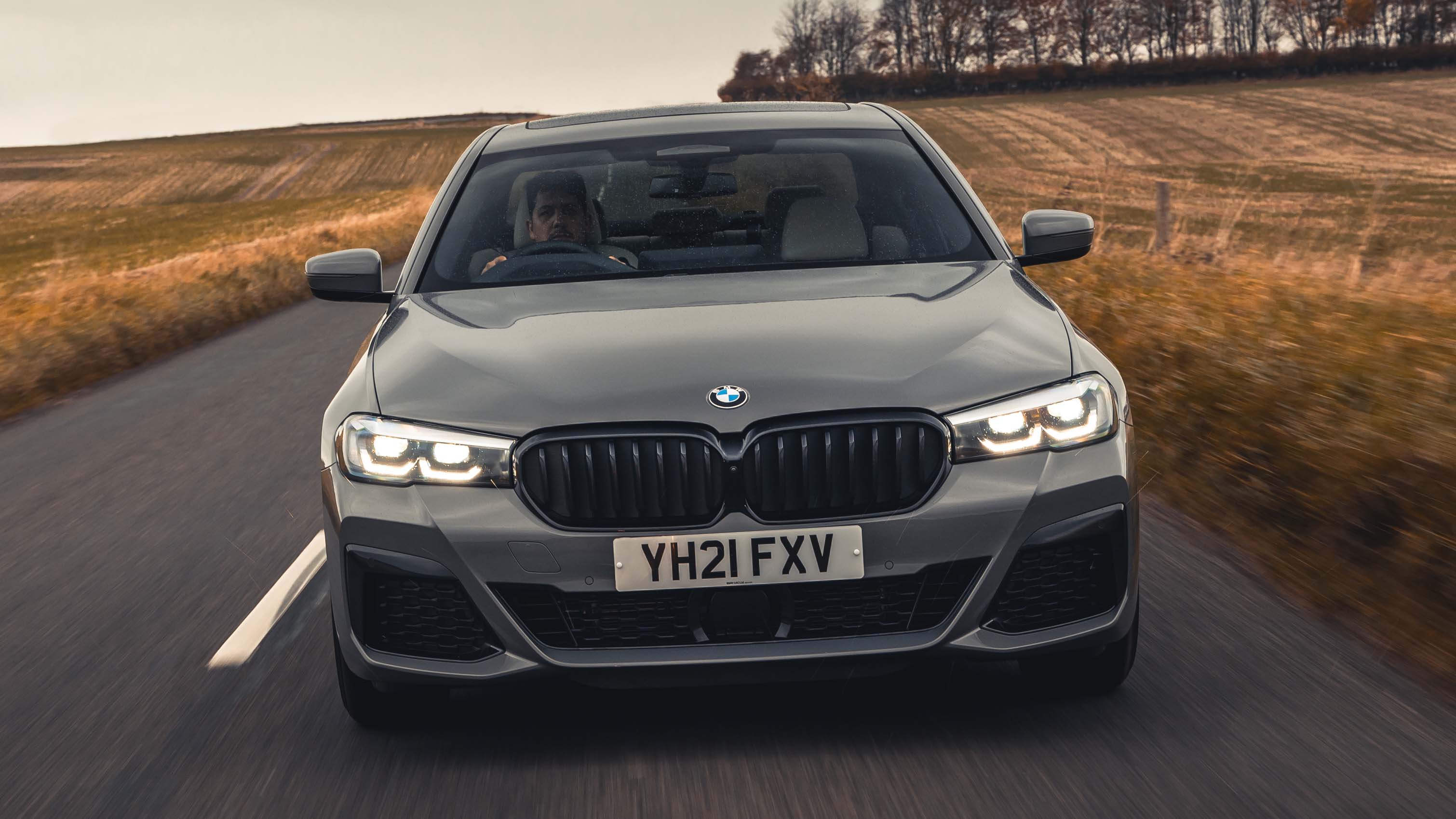 BMW 5 Series driving, front view