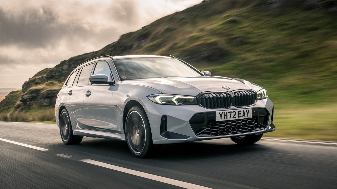 BMW 330e Touring in grey, driving shot