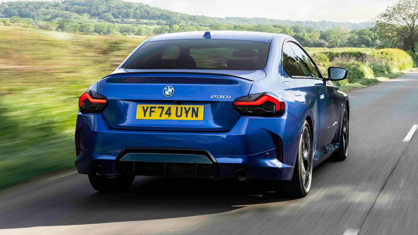 BMW 2 Series coupe driving rear view
