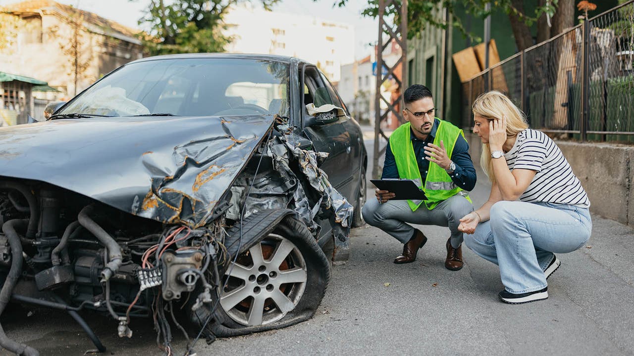 Driver being shown damage on car