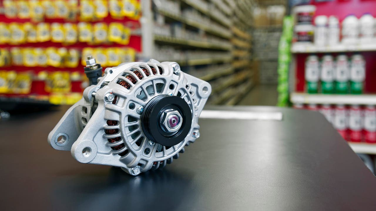 An alternator sits on a desk elegantly framed in front of shelves full of products