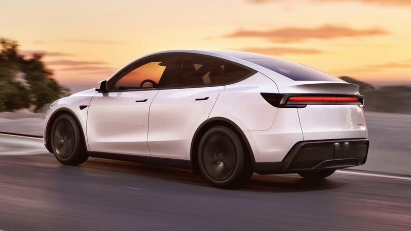 White Tesla Model Y facelift, driving rear sunset
