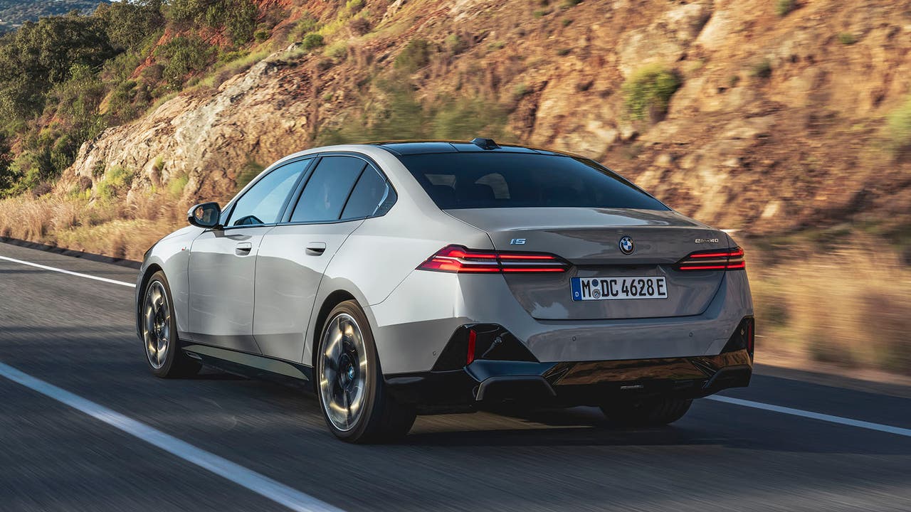 BMW i5 in grey, rear driving shot