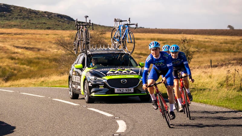 Mazda 6 Tourer following cyclists with bikes on roof