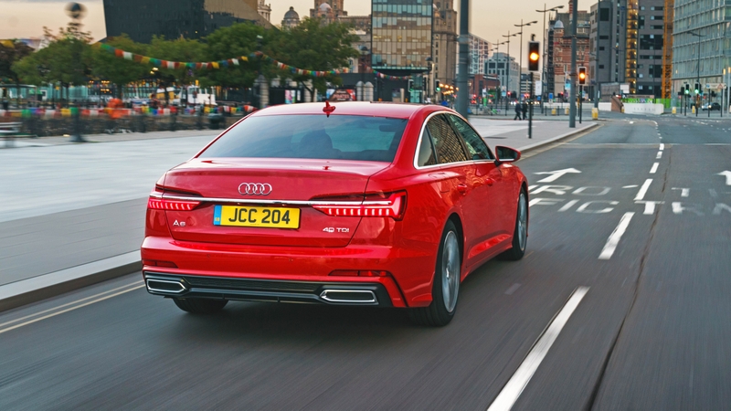 Audi A6 40 TDI driving through city, rear view