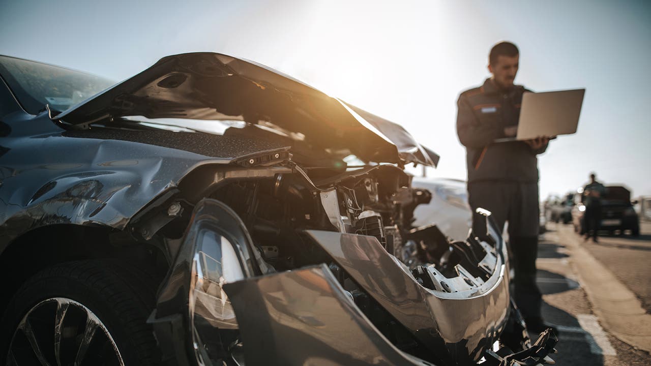 Crashed car being inspected