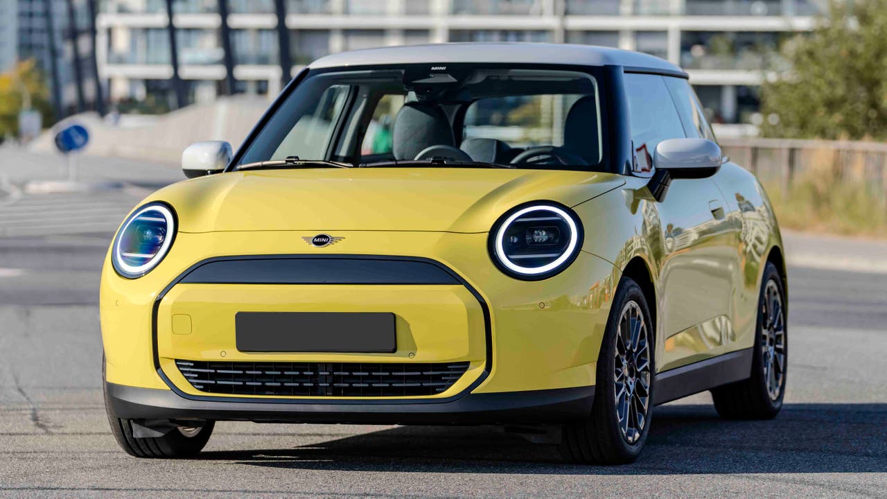 2024 Mini Cooper E in Classic trim with optional Sunny Side Yellow paint, black roof and 17-inch alloy wheels
