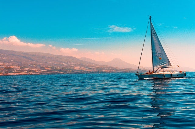 Sailing boat with mountains in the background