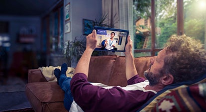 Watching tablet on sofa