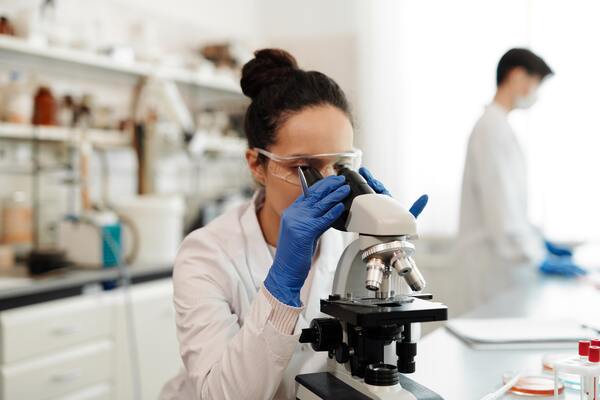 Scientist looking into microscope