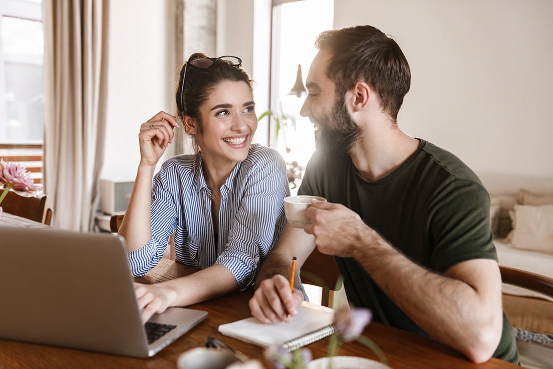 A smiling couple on a sofa