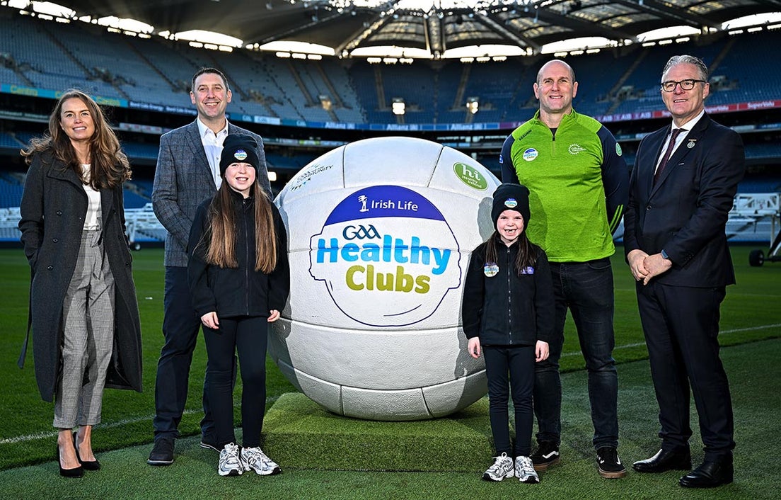 Irish Life and GAA staff with a giant Gaelic football bearing the GAA Healthy Clubs logo