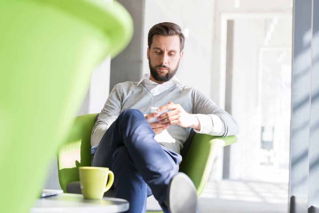 A girl child sitting on her dad with her mother beside her