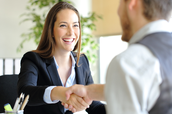 Woman shaking hands with a colleague in the office.
