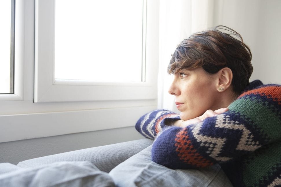 woman looking out window 